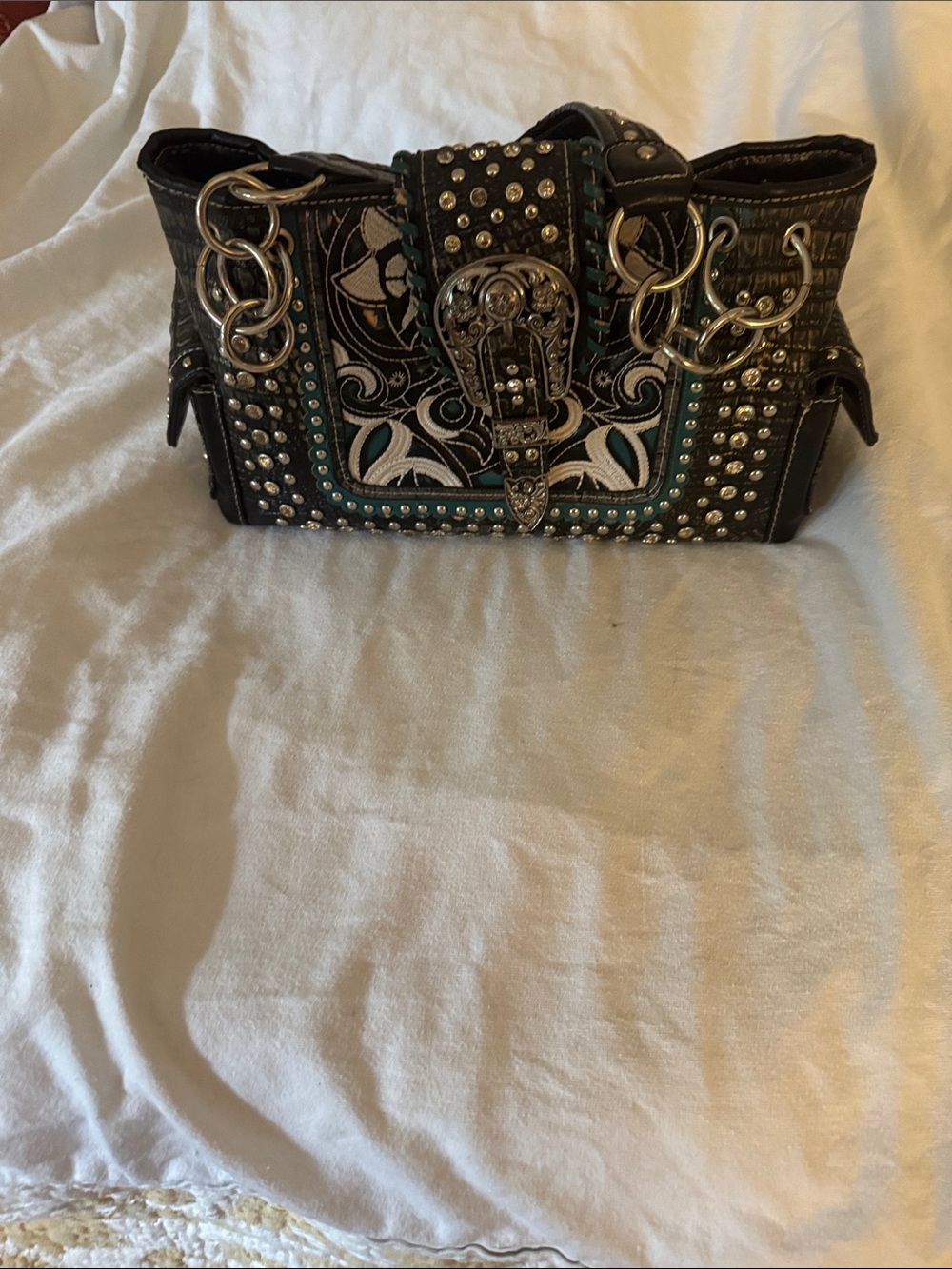 Studded Black Shoulder Bag with Teal Embroidery and Buckle Accent